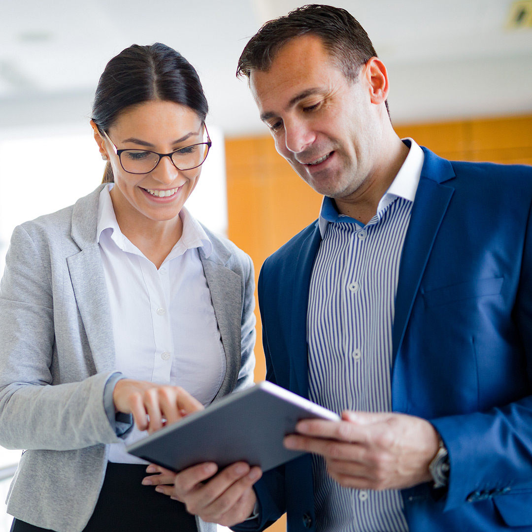 Business colleagues reviewing tablet together